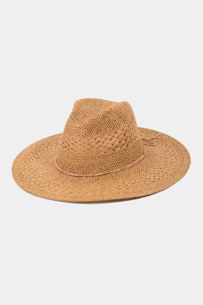 A wide-brimmed, woven straw hat with a slightly curved brim and a textured band around the base of the crown, perfect as a summer accessory offering excellent sun protection. The Fame Straw Braided Sun Hat by Marianela's Exclusive Shop, LLC is placed against a plain white background.