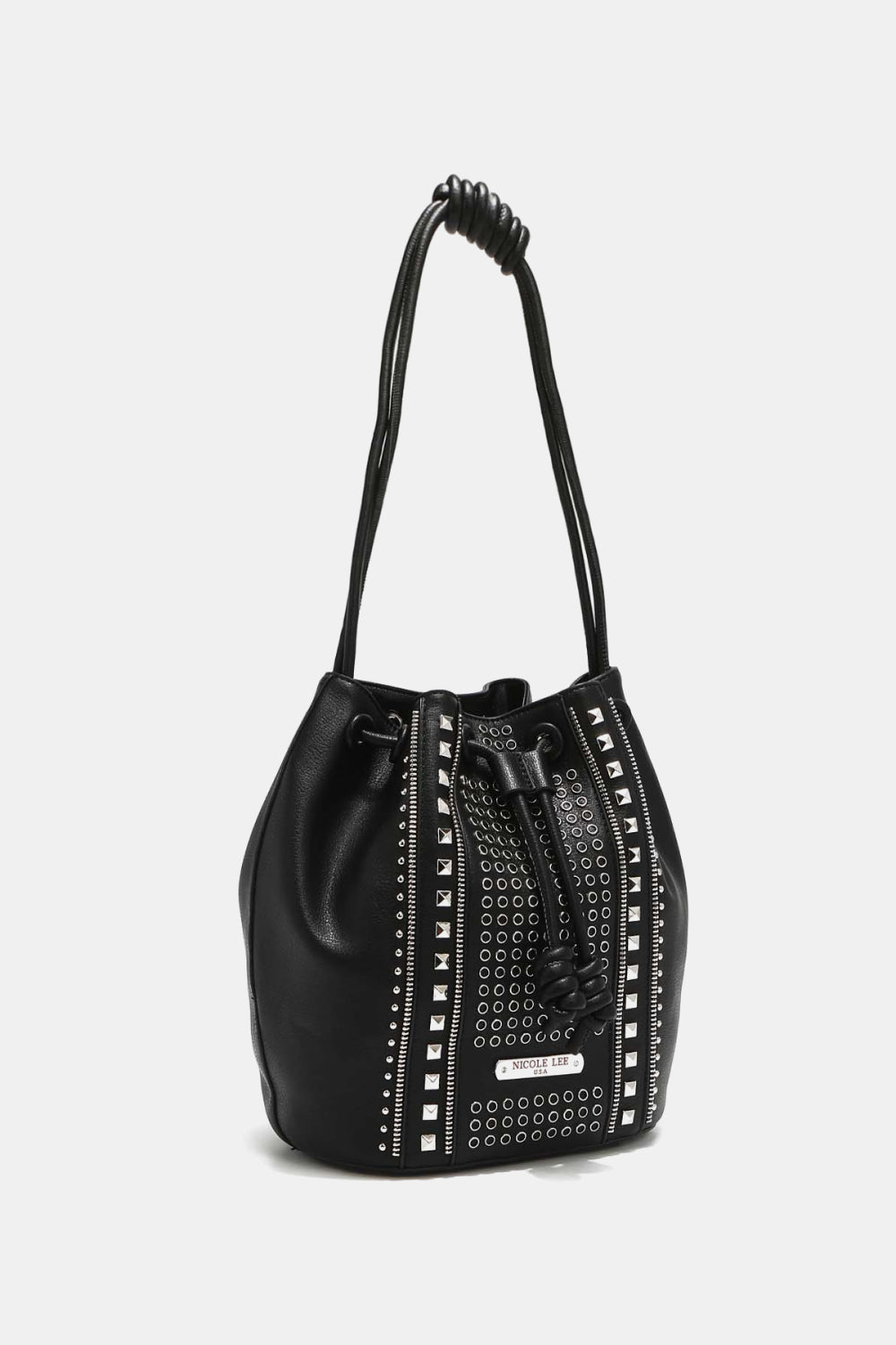 The Nicole Lee USA Amy Studded Bucket Bag from Marianela's Exclusive Shop, LLC is a black drawstring bucket bag made from pebbled vegan leather. It features two knotted shoulder straps and is adorned with metallic studs and grommets arranged in vertical rows, giving it a stylish and edgy appearance. The bag also includes both drawstring and snap button closures for added security.