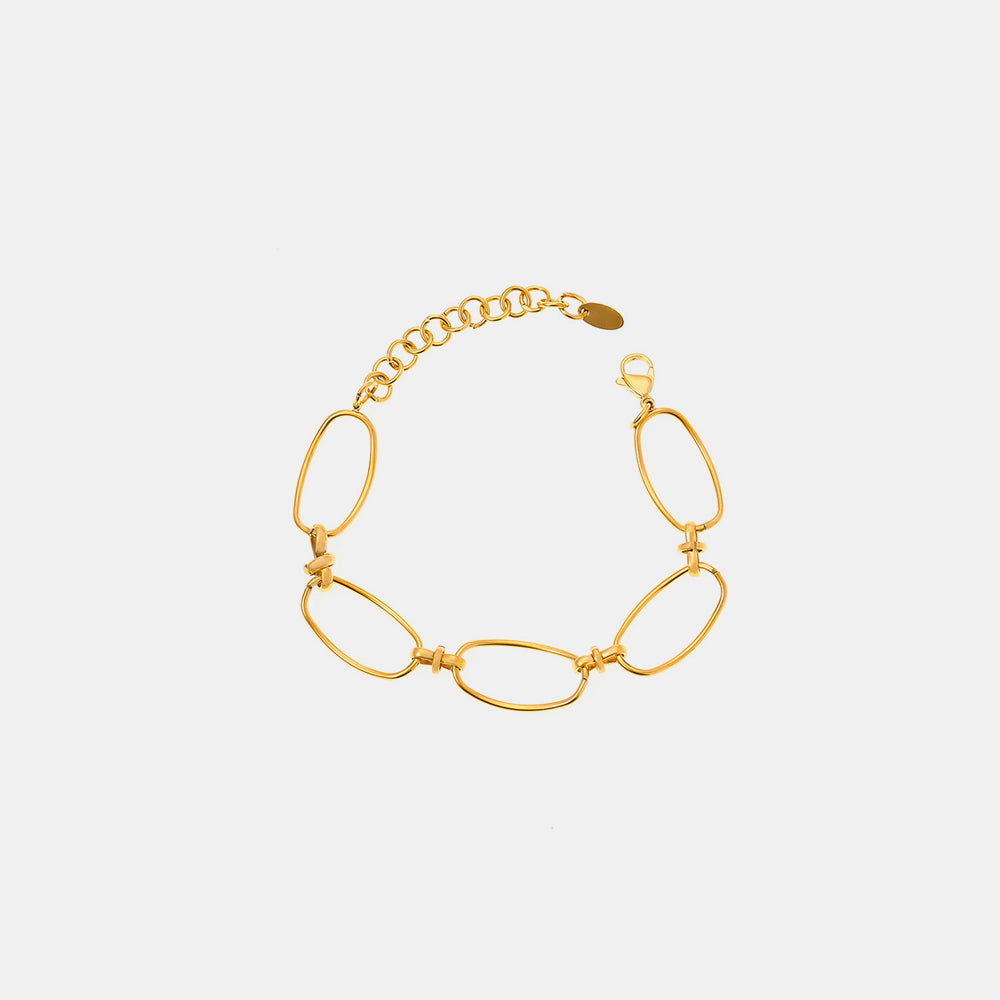 The Gold Hollow Chain Bracelet from Marianela's Exclusive Shop is a breathtaking piece, featuring large oval links crafted in 18K gold plating, elegantly arranged in a circle against a plain white backdrop. This contemporary design includes a small, adjustable titanium steel chain and clasp to ensure secure fastening.