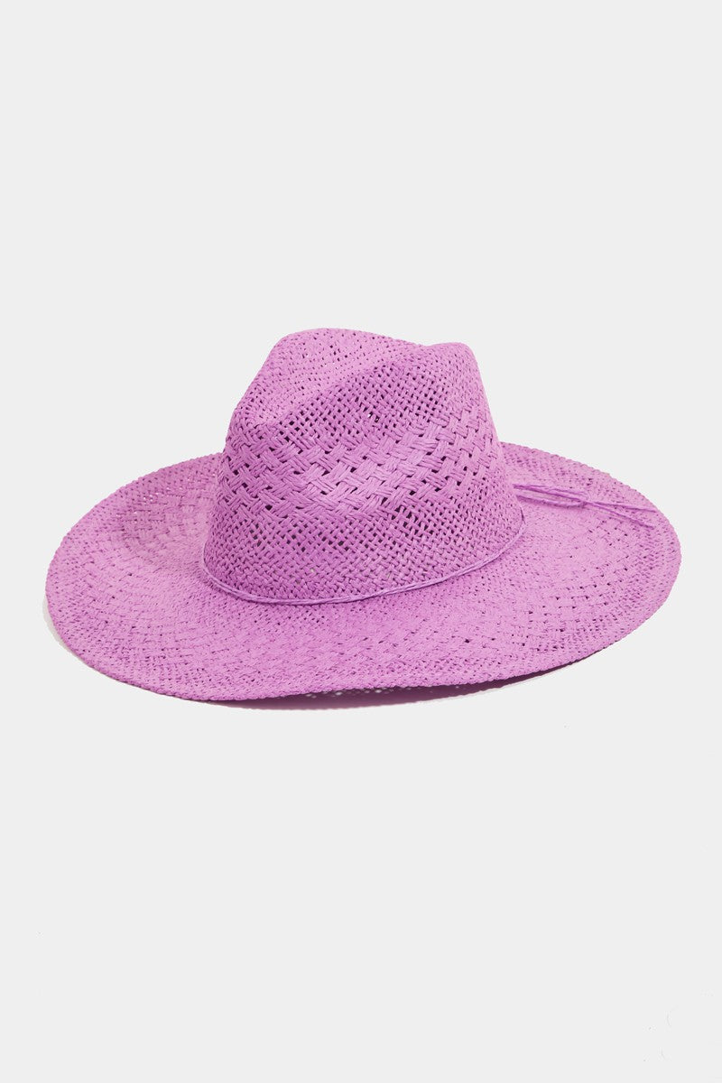 A lilac-colored, wide-brimmed Fame Straw Braided Sun Hat from Marianela's Exclusive Shop, LLC is displayed against a plain white background. The hat features a woven texture and a slight crease at the top for a classic design, offering both style and sun protection—making it the perfect summer accessory.