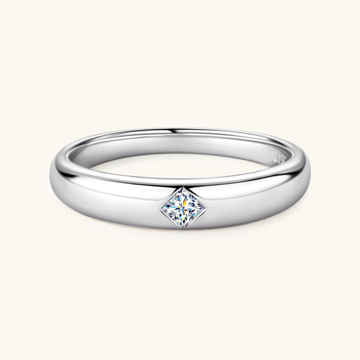 Discover the simple elegance of Marianela's Exclusive Shop, LLC's 925 Sterling Silver Inlaid Moissanite Band Ring. This ring features a small square-cut moissanite stone set at its center, with a smooth and polished band that subtly reflects light.