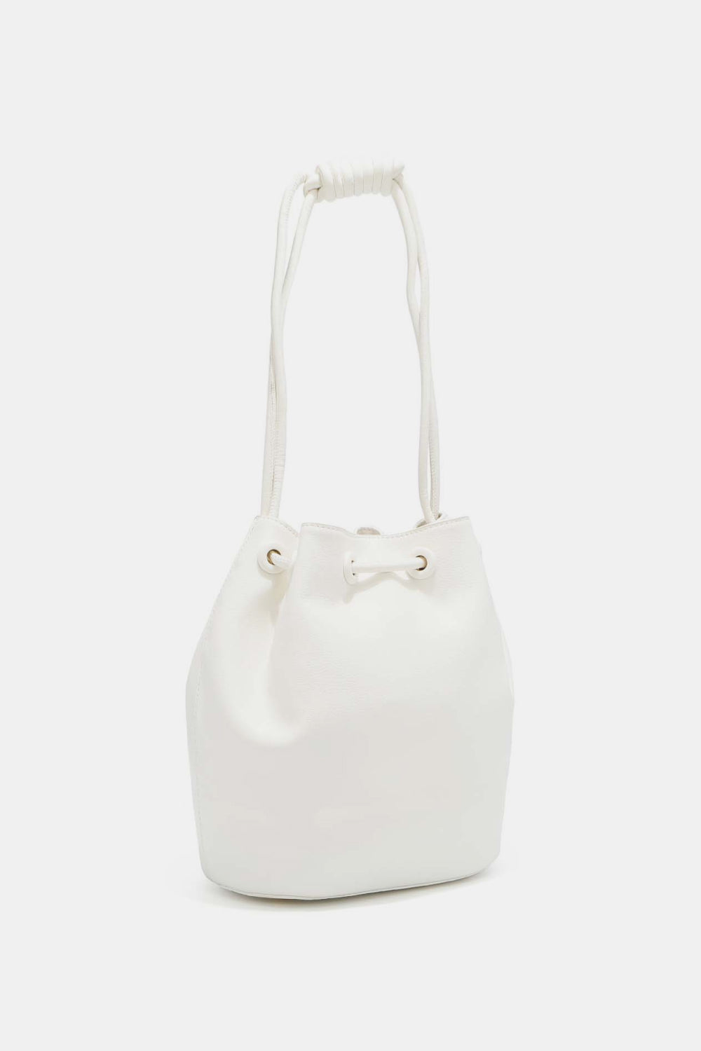 The Nicole Lee USA Amy Studded Bucket Bag from Marianela's Exclusive Shop, LLC is a white bucket handbag featuring a drawstring and snap button closure with two shoulder-length straps knotted at the ends. It boasts a minimalist design and a smooth surface without any additional patterns or embellishments.