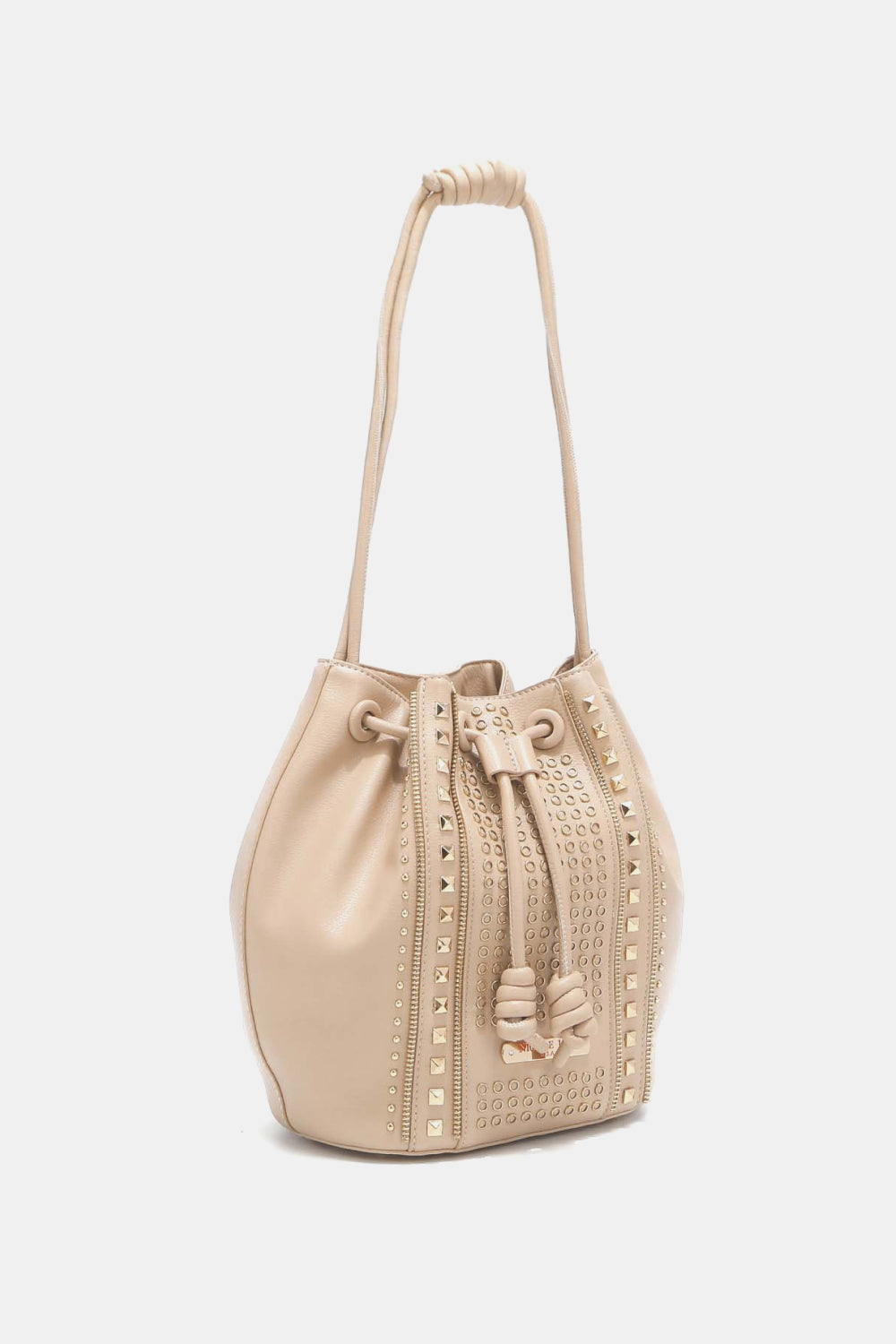 The Nicole Lee USA Amy Studded Bucket Bag from Marianela's Exclusive Shop, LLC is crafted from beige pebbled vegan leather and adorned with gold-tone studs. It features a drawstring closure, two carrying straps, and decorative stitching along the front.