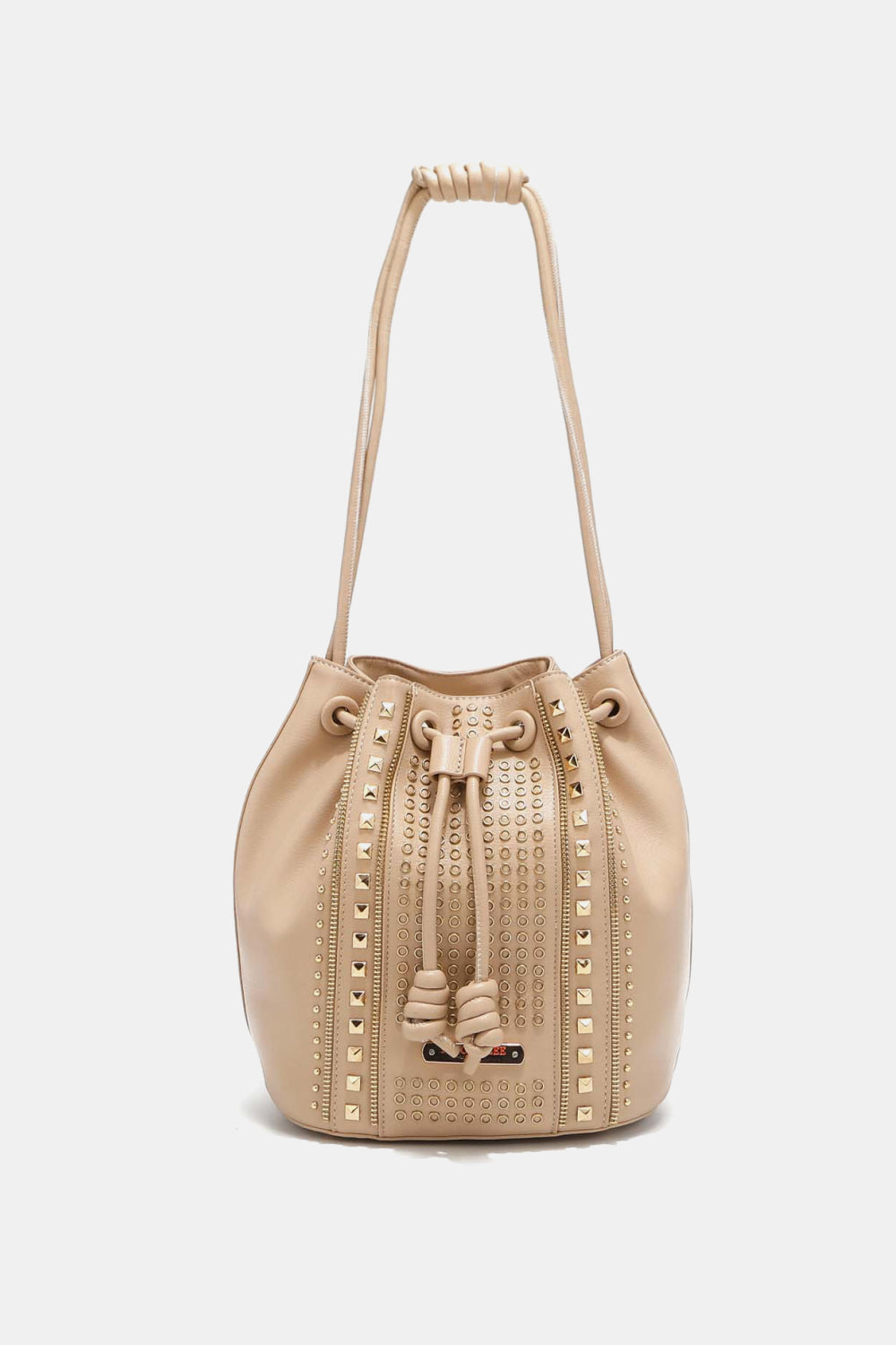 The Nicole Lee USA Amy Studded Bucket Bag, available at Marianela's Exclusive Shop, LLC, is a beige bucket bag crafted from pebbled vegan leather. It features a drawstring and snap button closure and is adorned with gold studs and eyelets along the vertical seams and around the top edge. The drawstrings end in knots, and the straps are looped at the top. The background is plain white.

