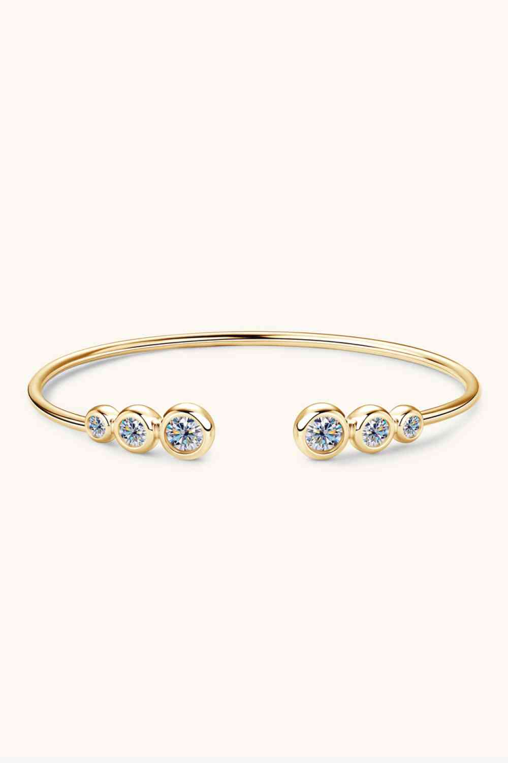 A minimalist 1.8 Carat Moissanite 925 Sterling Silver Bracelet with an open design, featuring three round, sparkling moissanite gemstones on each end. The sleek, delicate bracelet from Marianela's Exclusive Shop, LLC rests on a light, off-white background.