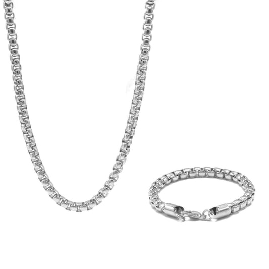 A Box Chain and Bracelet Set- Silver from Marianela's Exclusive Shop, LLC consisting of a chain necklace and a matching bracelet, both featuring a box chain design. The necklace is extended vertically, while the bracelet is coiled in a circular shape.