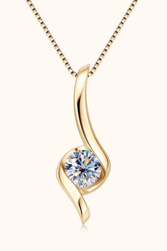 Introducing the 1 Carat Moissanite 925 Sterling Silver Necklace by Marianela's Exclusive Shop, LLC, featuring an elegant, wavy design with a radiant, round-cut gem at its center. The pendant hangs from a fine 925 sterling silver chain, combining sophistication and simplicity in eco-friendly jewelry.